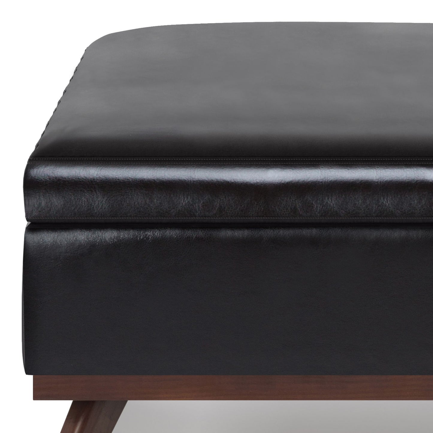 Close-up of the Owen Multifunctional Square Coffee Table Storage Ottoman in black leather, featuring visible stitching, a thick cushioned top, and sturdy wooden legs.