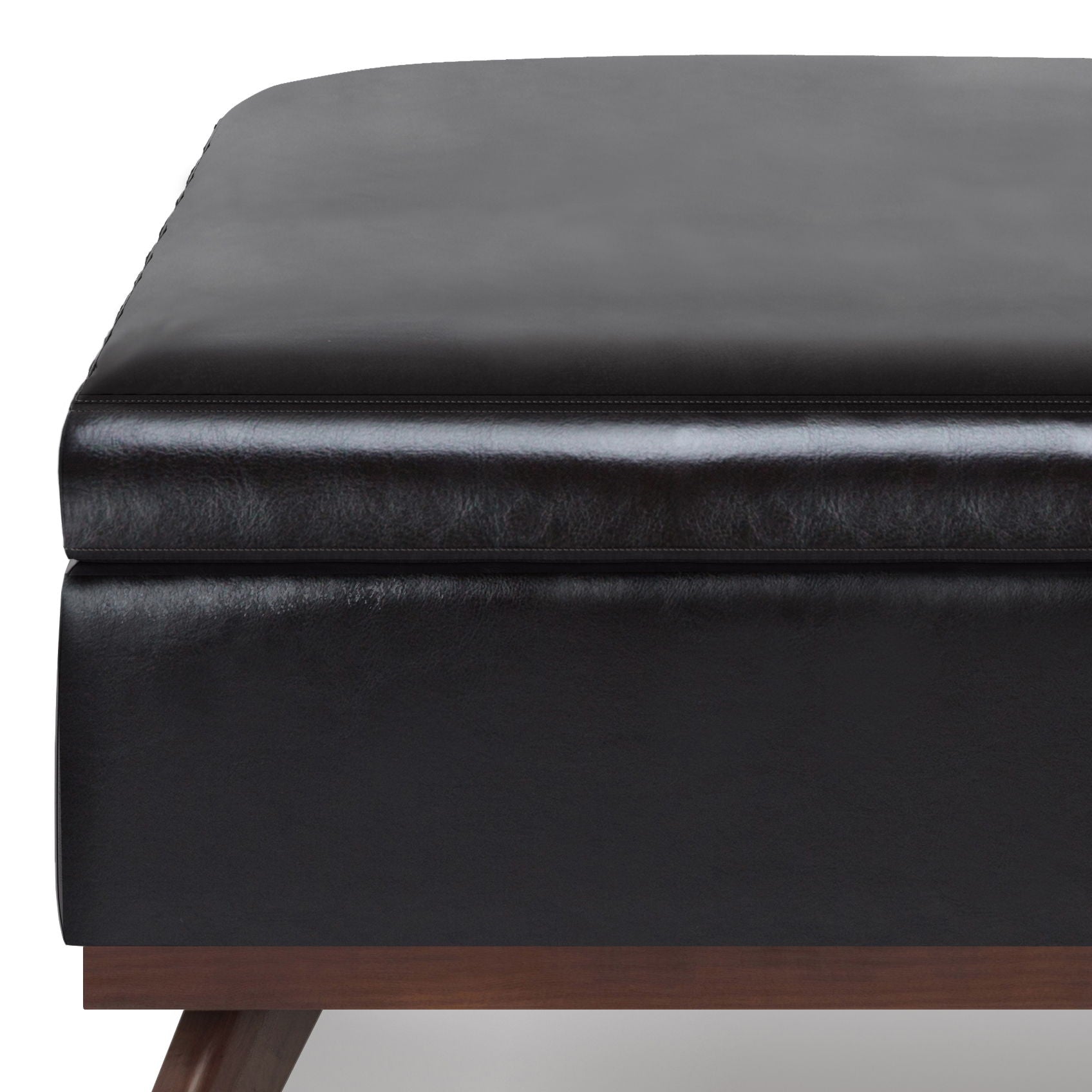 Close-up of the Owen Multifunctional Square Coffee Table Storage Ottoman in black leather, featuring visible stitching, a thick cushioned top, and sturdy wooden legs.