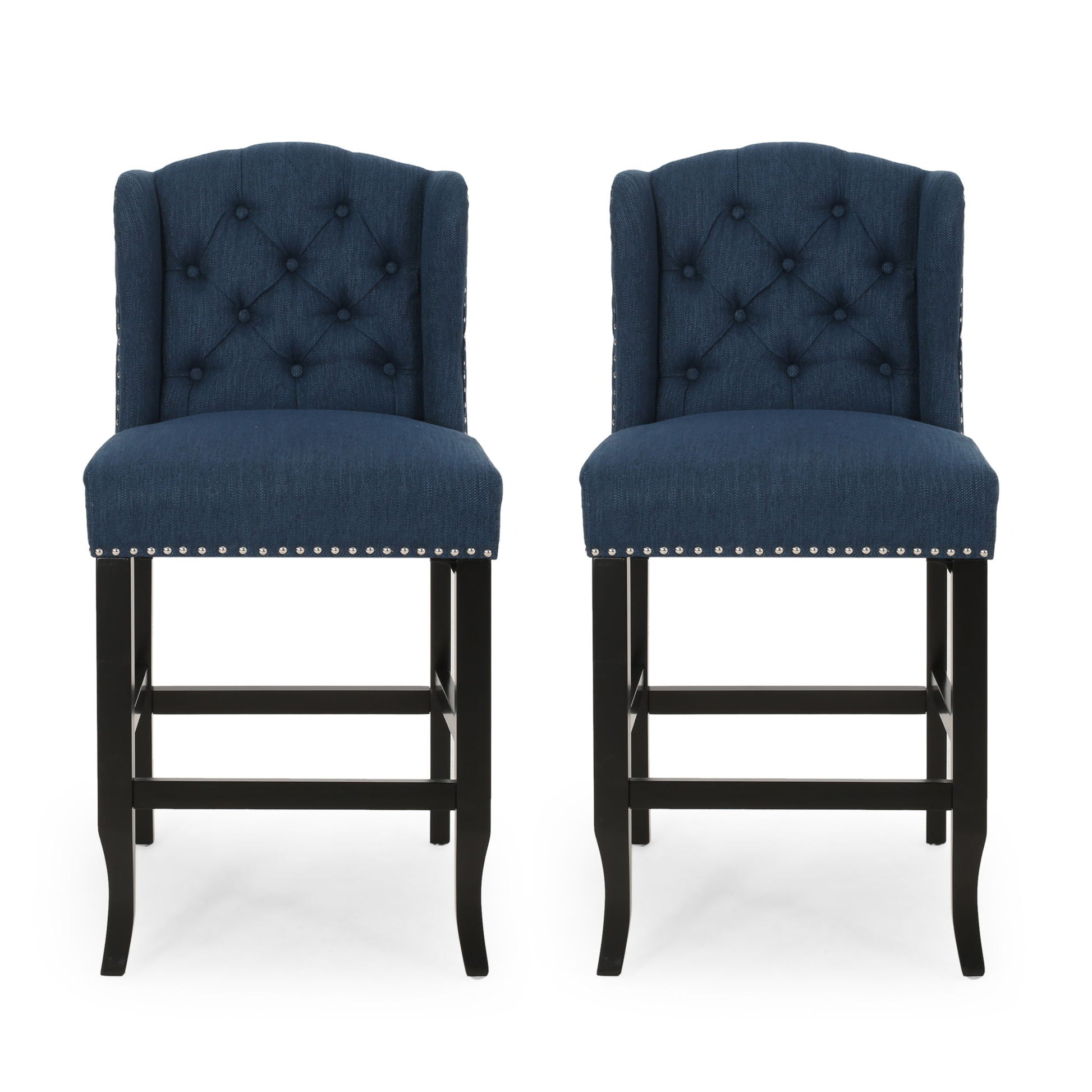 The Vienna Fabric Tufted Counter Stool With Nailhead Accents (Set of 2) features navy blue upholstery, button-tufted backs, silver nailhead trim, and dark wooden legs, shown side by side against a white background.