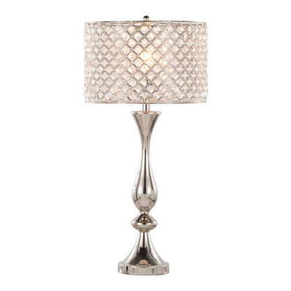 The Topaz Contemporary Table Lamp features a shiny, curvy silver base and a drum-shaped shade adorned with a diamond-patterned crystal design for an elegant, luxurious look.