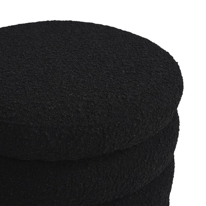 A close-up view of three stacked Fuji Oversized Round Storage Ottomans in black, showcasing their textured finish against a white background.