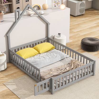 The House-Shaped Headboard Floor Bed With Fence in gray features a low gate, two yellow pillows, gray blanket, and beige throw, set on a light rug in a bright modern children’s room with wooden floors.