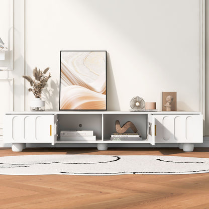 A Modern TV Stand for TVs up to 80" with glass door, 2 drawers, and cabinets displays abstract art, decor, books, and a vase on a light wood floor with a white and black rug in a bright, minimalist living space.