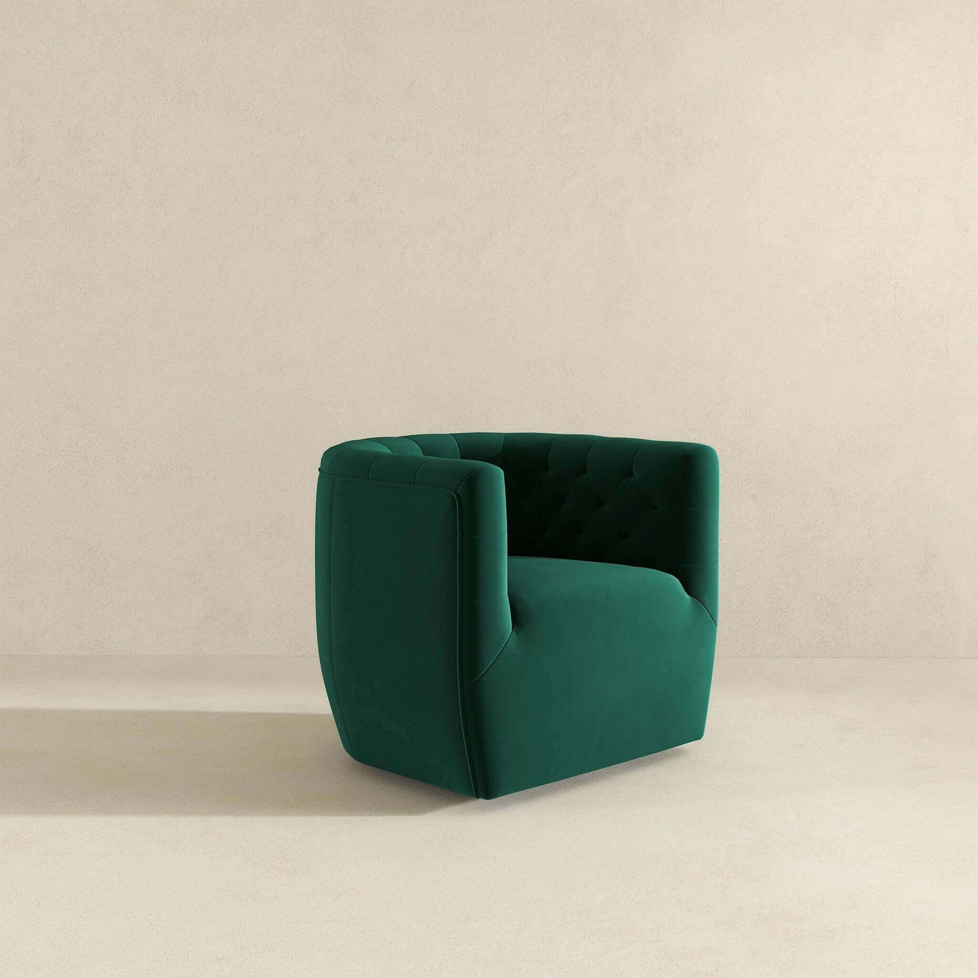 The Delaney Ergonomic Design Swivel Chair, featuring modern green velvet upholstery and a tufted backrest, stands on a light beige floor against a matching plain beige wall.