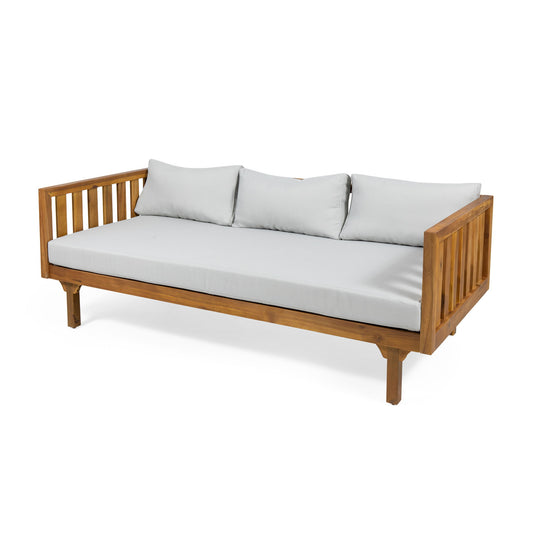 Claremont 3 Seater Daybed, crafted from teak acacia wood with vertical slat sides and back, includes light gray water-resistant seat and back cushions. Shown on a white background.