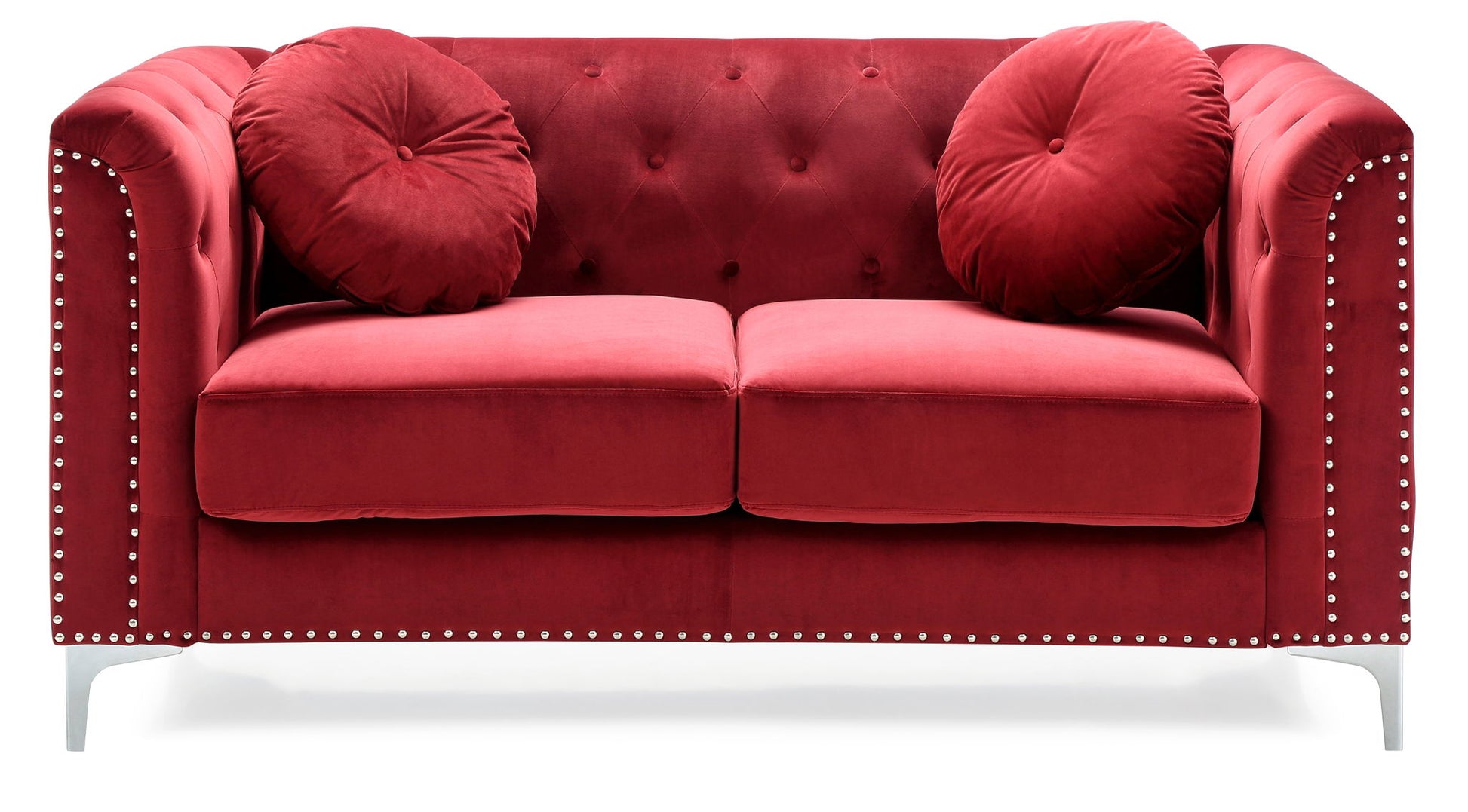 The Stylish Sloped Arm Loveseat features a red velvet finish, tufted backrest, silver studded arms, two round matching cushions, and short silver legs, shown against a white background.