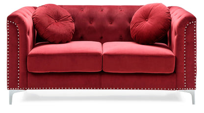 The Stylish Sloped Arm Loveseat features a red velvet finish, tufted backrest, silver studded arms, two round matching cushions, and short silver legs, shown against a white background.