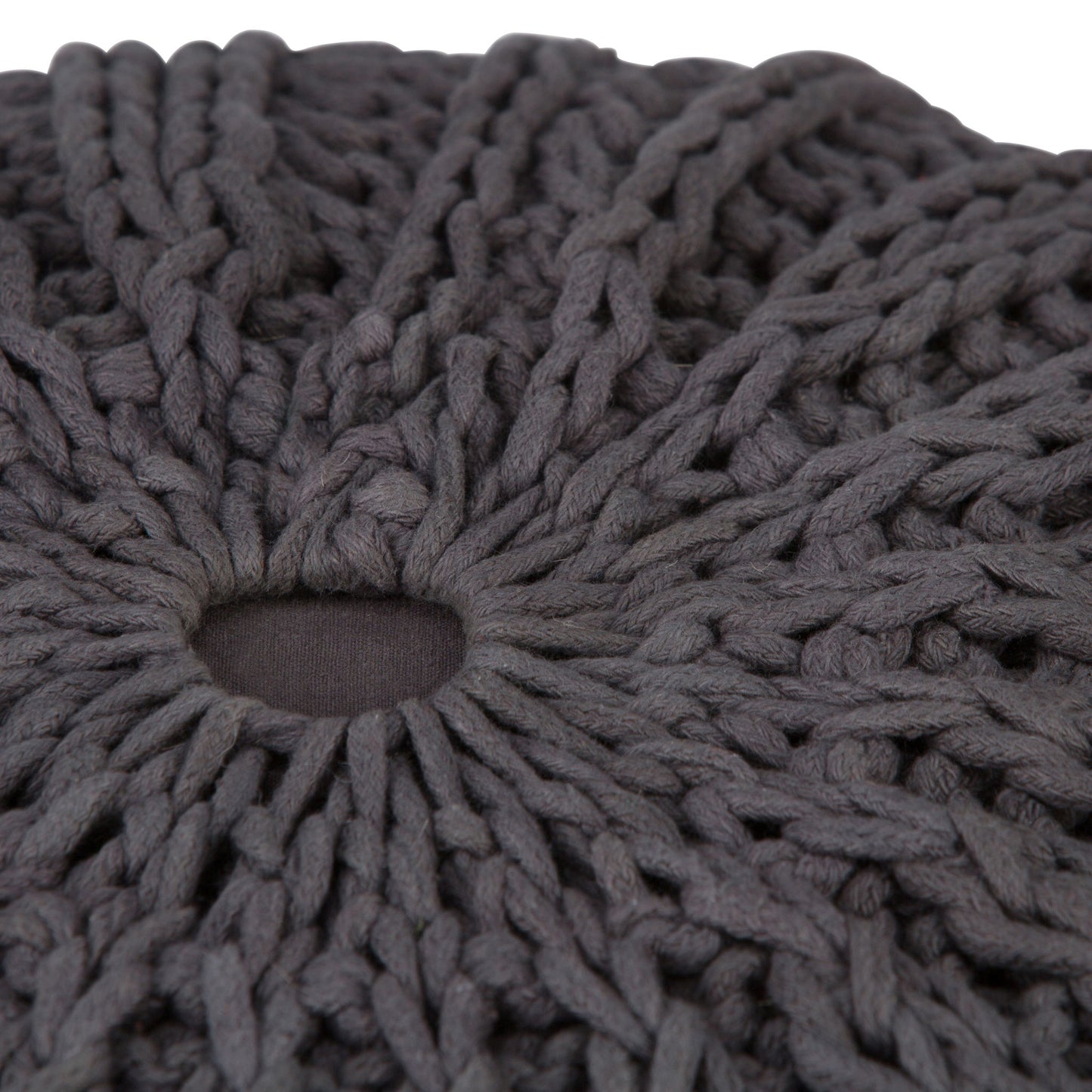 Close-up of the Shelby - Handcrafted Hand Knit Round Pouf, featuring thick, dark gray yarn with a small central hole that highlights the detailed texture and pattern of its knitted stitches.