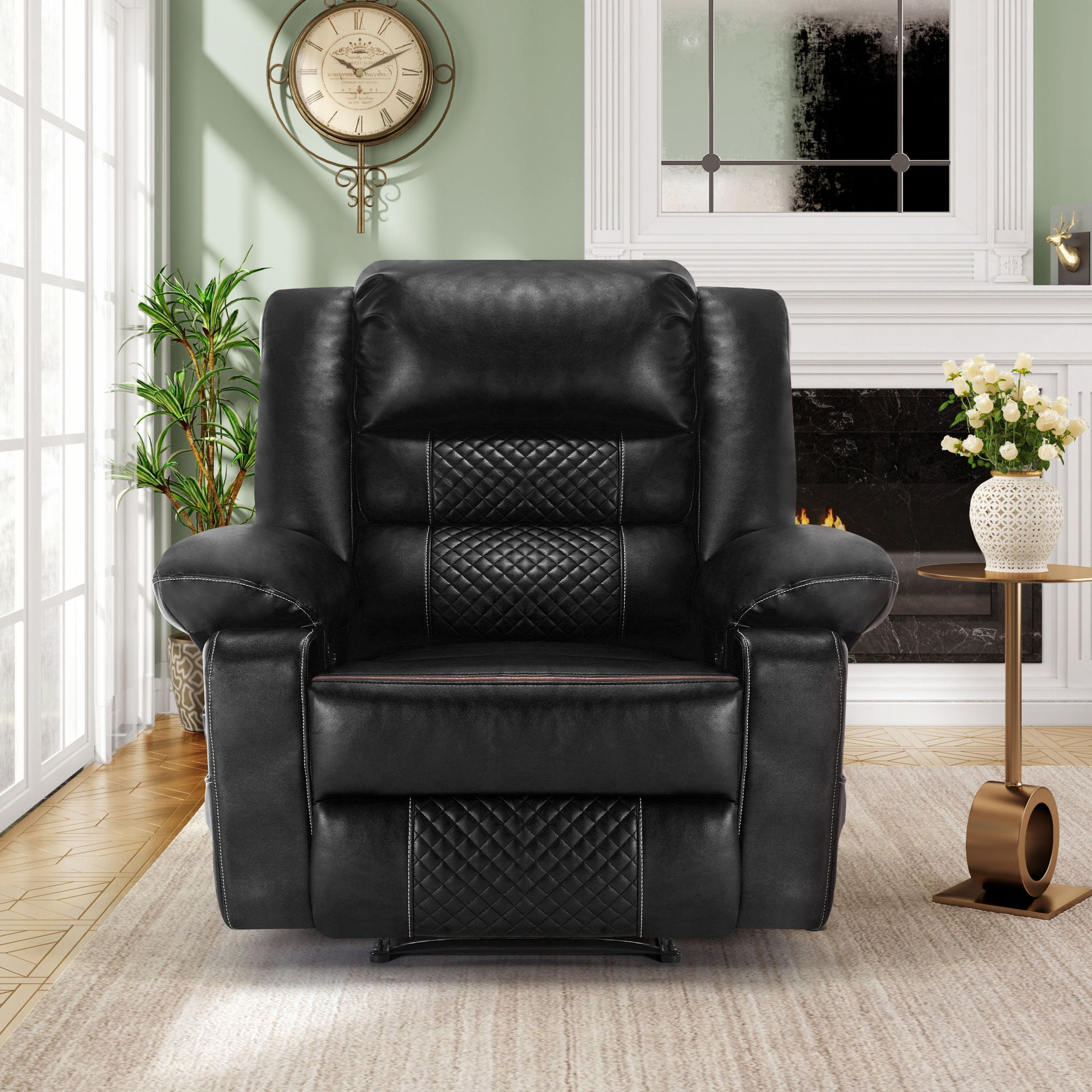 The Breathable Leather Massage Recliner Manual Chair in black is centered in a living room, with a fireplace, decorative clock, white vase with flowers, plant, and sunlit window behind it.