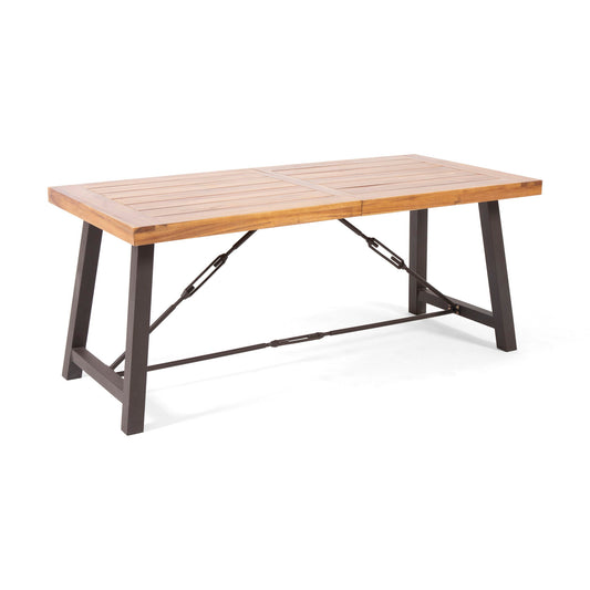 The Outdoor Dining Table With Slat Wooden Panel And Turnbuckle Accents - Teak features a rectangular slatted wood top, sturdy black metal legs, and diagonal turnbuckle accents for enhanced stability.