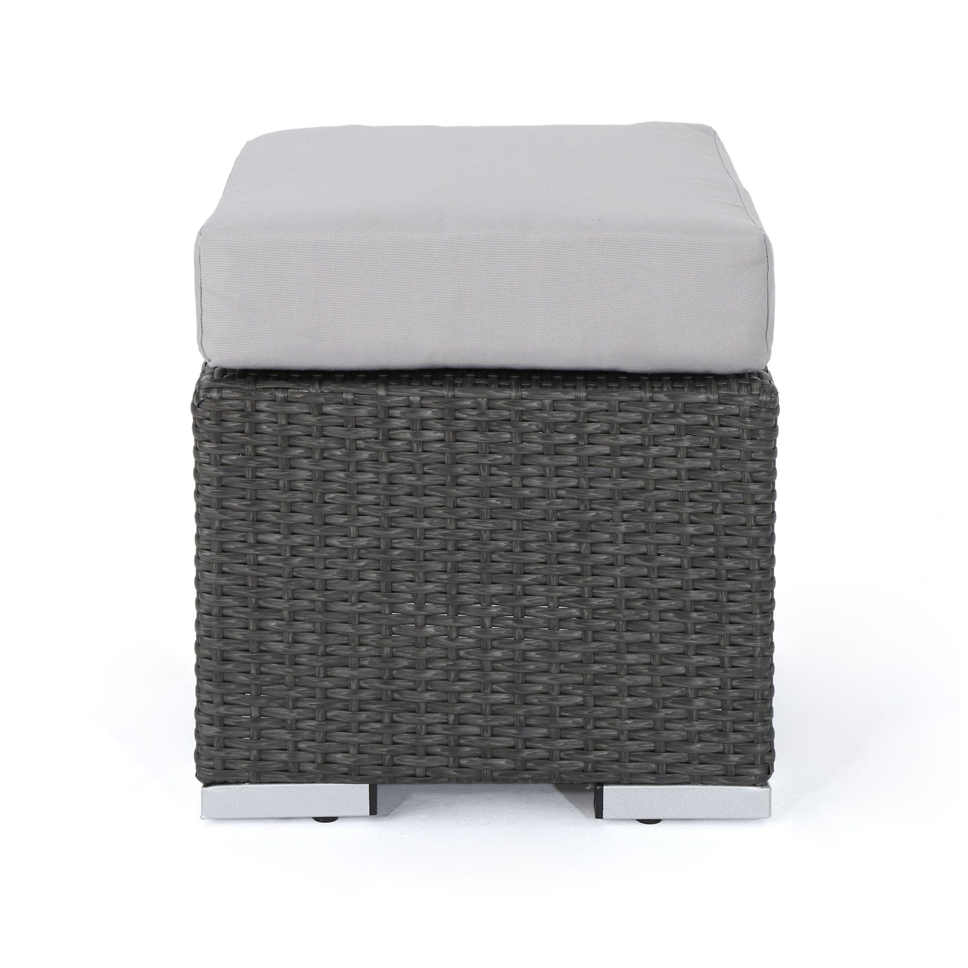 The Santa Rosa - Outdoor Lounge Ottoman features a square design with a dark woven rattan base and a light gray cushioned top, displayed against a plain white background.