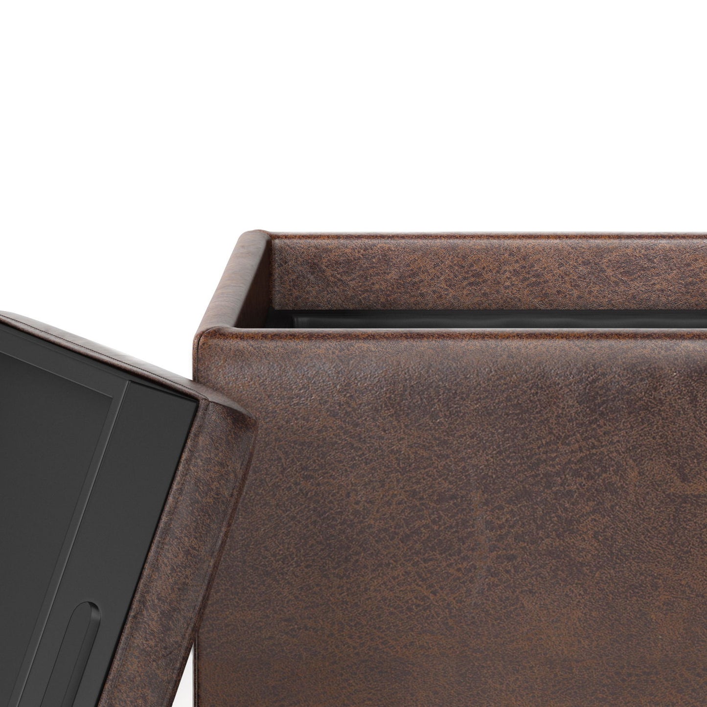 Close-up of the Rockwood Upholstered Cube Storage Ottoman With Tray in brown, featuring a slightly textured, worn look. A black electronic device is partially visible beside the ottoman.