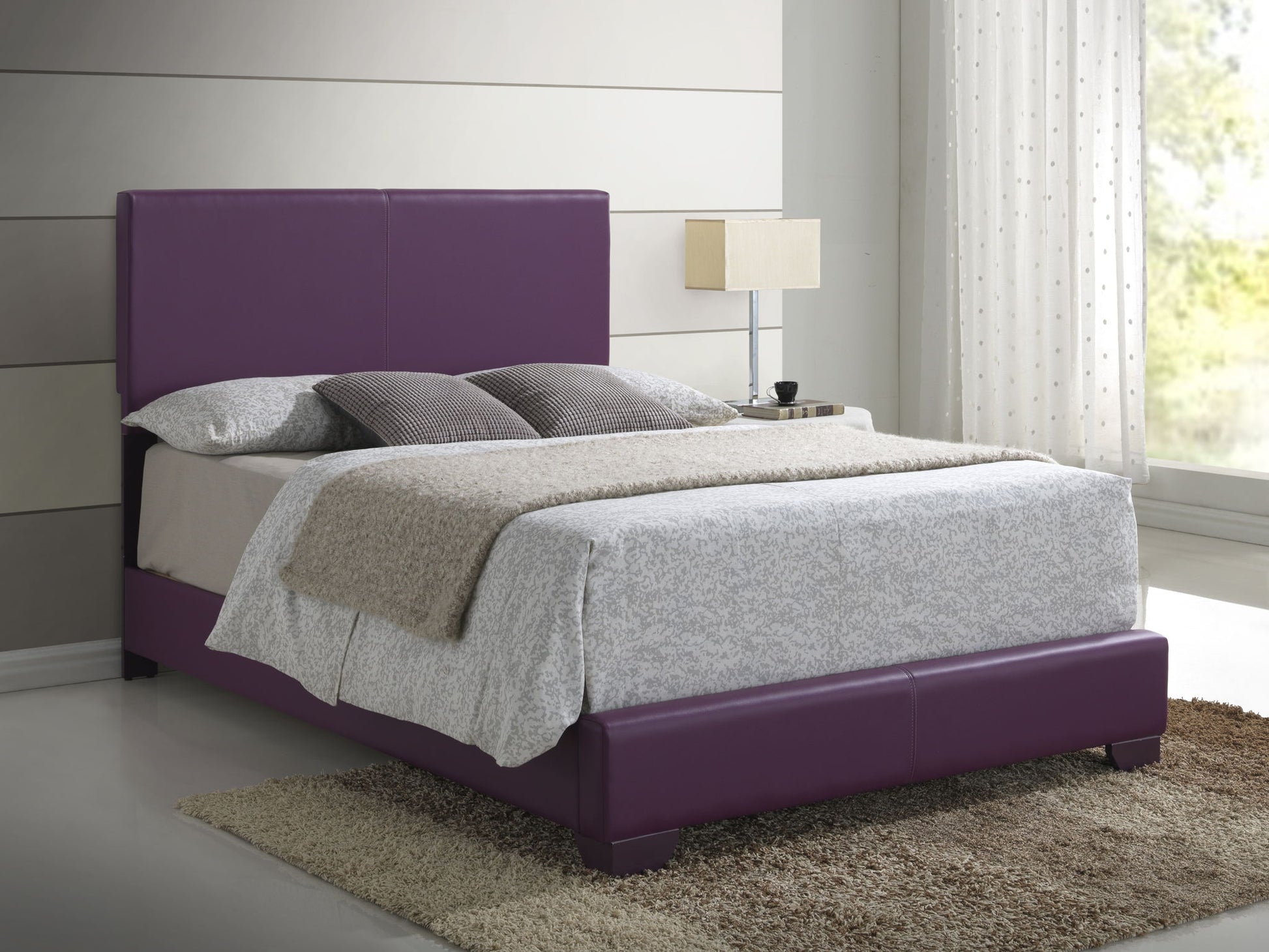 A modern bedroom featuring the Elegant Platform Bed For Relaxed Spaces in purple upholstery, styled with neutral bedding and gray pillows. A beige rug is underneath, and a nightstand with a lamp stands by the window with sheer curtains.