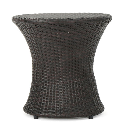 The Thrive Hourglass Rattan Table features a small, dark brown, woven rattan design with an hourglass shape, smooth flat top, and slightly flared base. No glass top included.