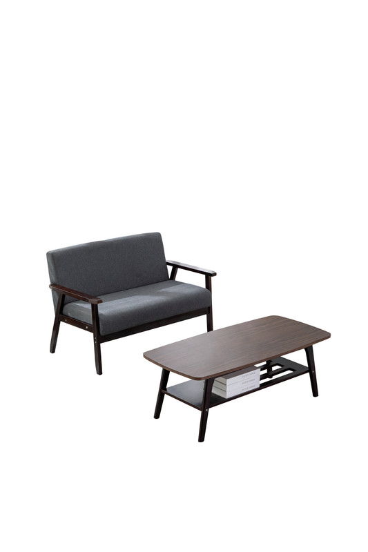 The Bahamas - Living Room Set features a modern gray two-seater sofa with dark wood arms and legs, paired with a matching coffee table with a lower shelf for books, all set against a white background.