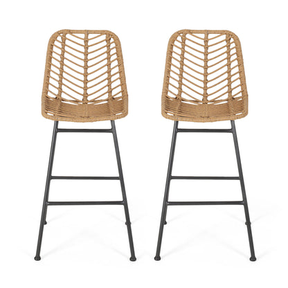 The Sawtelle Outdoor Wicker Barstools (Set of 2) feature tall chairs with chevron-patterned woven rattan seats and backs, slender black metal legs, and footrests, all displayed against a plain white background.