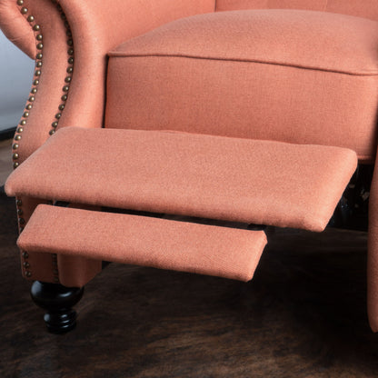 Close-up of the Contemporary Style Push Back Recliner, featuring pink upholstery, button tufted stitching, nailhead trim, an extended footrest, and black wooden legs on a dark floor.