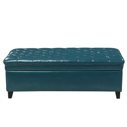 The Juliana Storage Ottoman features a teal tufted leather design, cushioned lift-up lid for hidden storage, and dark birch legs.