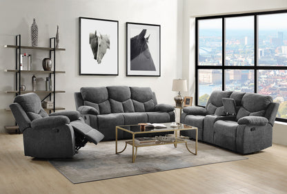 A modern living room with the Kalen Chenille 3 Piece Recliner Living Room Set in gray, a glass coffee table, beige rug, decorative shelves, framed horse art on the wall, and large windows revealing a cityscape view.
