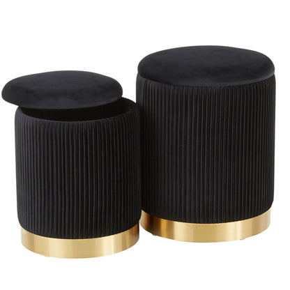 The Marla - Contemporary Nesting Pleated Ottoman Set features two round, black velvet ottomans with gold bases. One shows hidden storage with its lid removed. Both display pleated sides and a sleek, modern design.