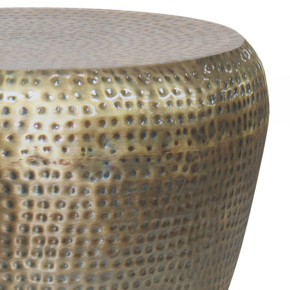 Close-up of the Preston Handcrafted Metal Side Table reveals its rounded, dimpled surface with a shiny, reflective finish in rich bronze and gold tones.
