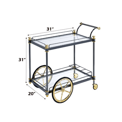 The Cyrus Clear Glass Serving Cart in Black/Gold features two glass tiers, large rear wheels, small front wheels, and measures 31"H x 31"W x 20"D.