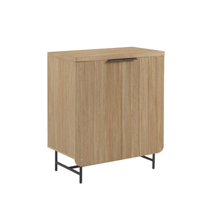 The Couch.com Modern Scandi Fluted Door Storage Console features a light brown coastal oak finish, fluted (vertical grooves) door, flat top, single handle, curved bottom corner, black metal legs, and a durable minimalist design.