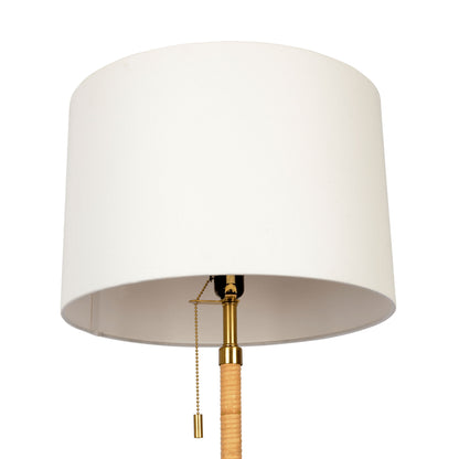 The Stellar Linen Shade Floor Lamp features a large white cylindrical shade, gold accents, a pull chain switch, and a natural wood and rattan-wrapped stem.
