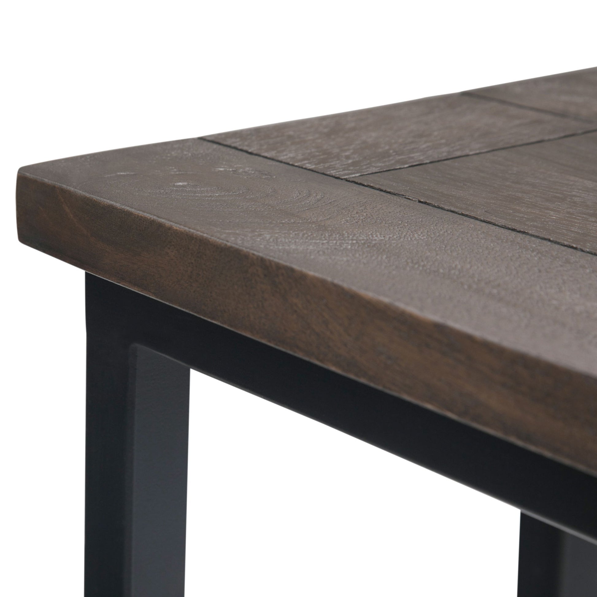 Close-up of the corner of the Skyler - C Side Handcrafted Table, highlighting its dark wooden top with visible grain and black metal legs.