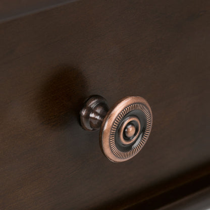 Close-up of a bronze round decorative drawer knob with a ridged edge, mounted on the Carlton Console Sofa Table in Dark Tobacco Brown. The knob casts a soft shadow on the table’s wood surface.