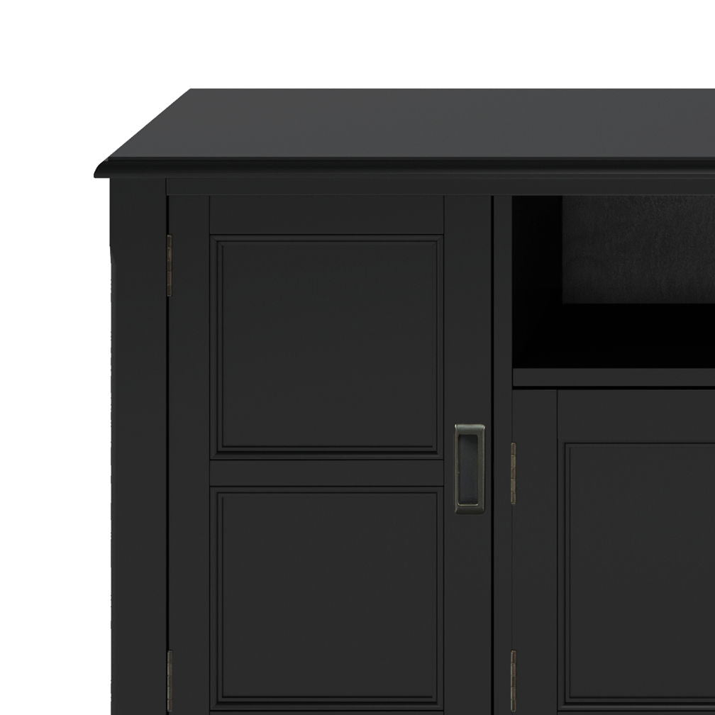 Close-up of the Burlington TV Media Stand in black wood, featuring a partial view of a side door with handle and an adjacent open shelf.