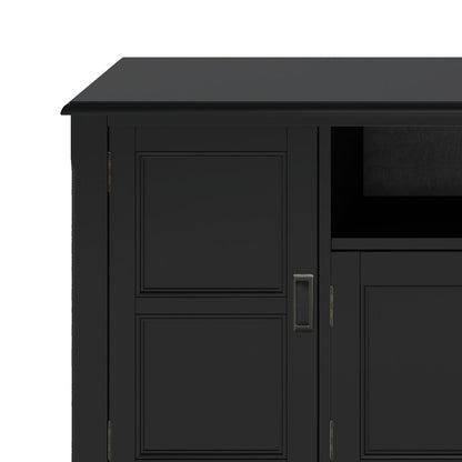 Close-up of the Burlington TV Media Stand in black wood, featuring a partial view of a side door with handle and an adjacent open shelf.