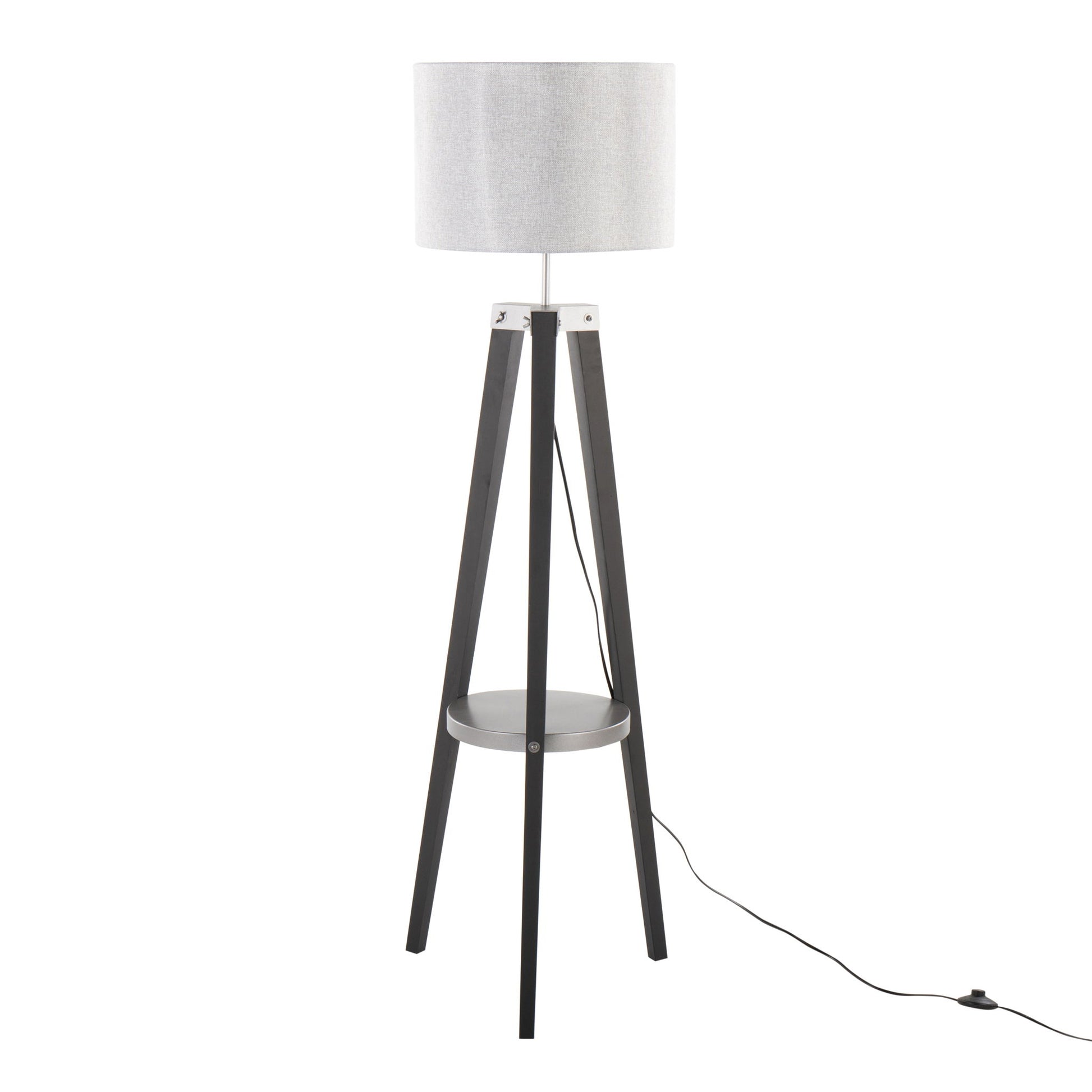 The Compass - Mid Century Modern Floor Lamp With Shelf features a white drum shade, black tripod legs, a round base shelf, and a black power cord that extends to the floor.