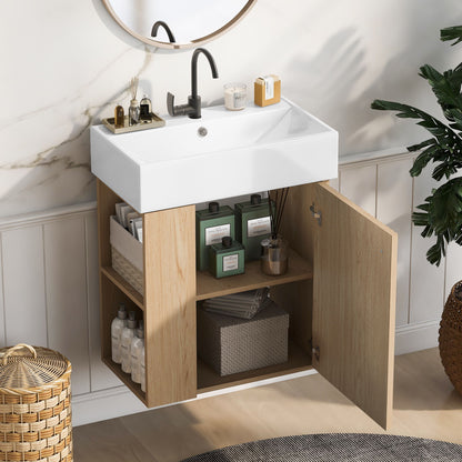 The Modern Floating Bathroom Vanity With Ceramic Basin features a white rectangular sink, black faucet, wooden cabinet with open shelves for bottles, storage for towels and boxes, plus a nearby round mirror and potted plant—ideal for small bathrooms.