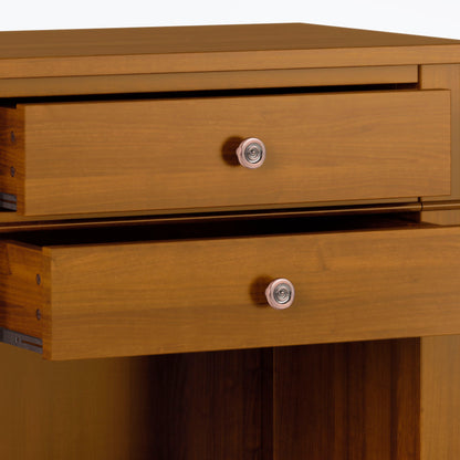 Close-up of the Carlton Handcrafted Bedside Table, showing two partially open drawers with round silver knobs and a warm medium-brown wood finish.