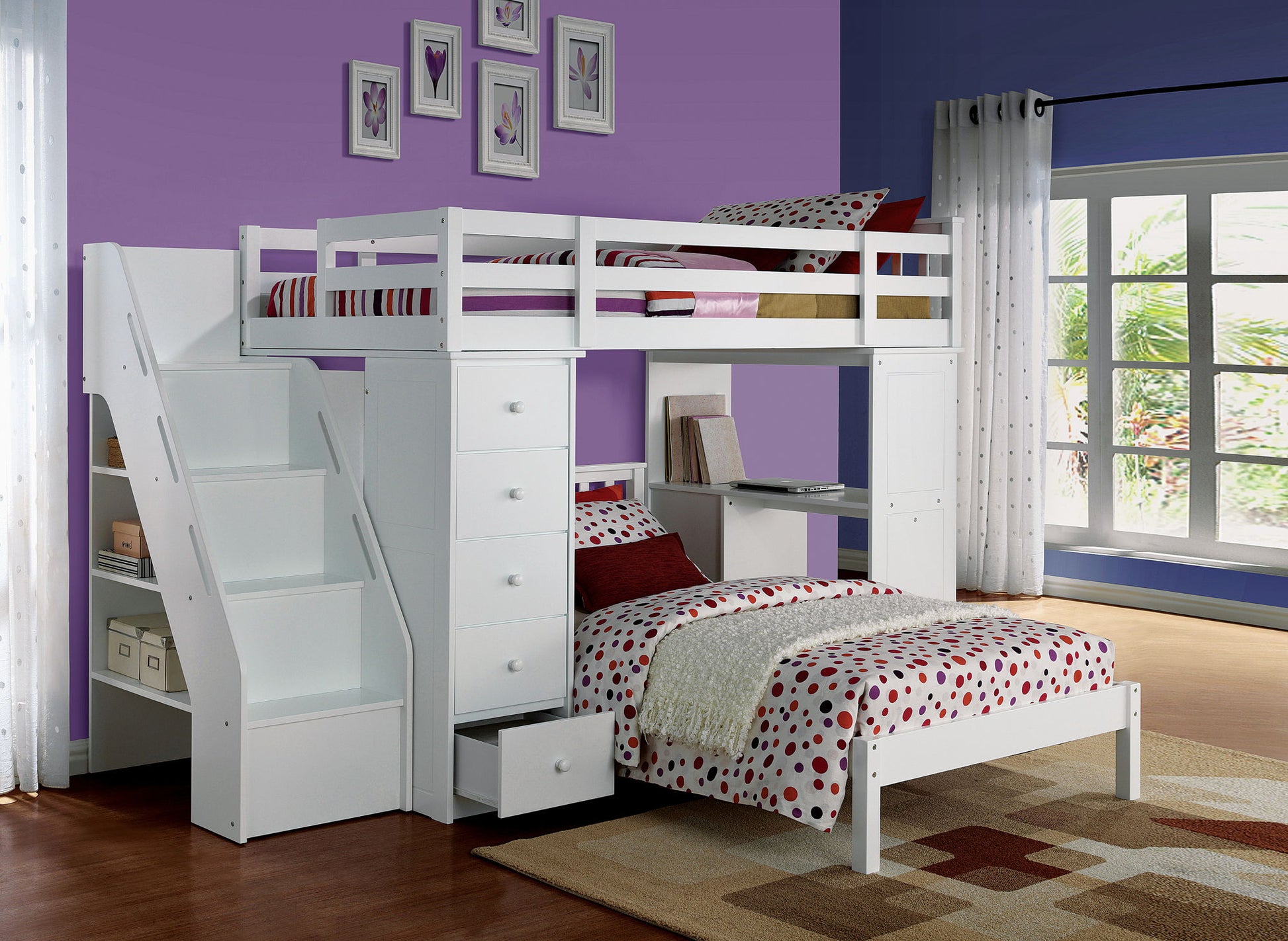 A modern bedroom with purple walls features the Freya Twin Loft Bed With Storage in white, complete with stairs, drawers, and a desk. A window with sheer curtains and framed art decorate the space. The bedding is red and white polka dots.