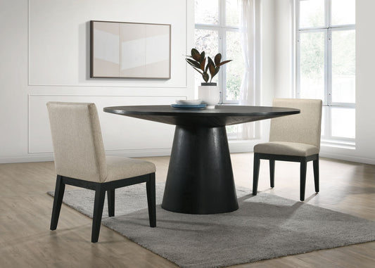 Create a modern dining area with the Jasper Wide Contemporary Round Dining Table and fabric chairs set, featuring beige chairs, a black table, gray rug, potted plant centerpiece, minimalist artwork, and large sunlit windows.