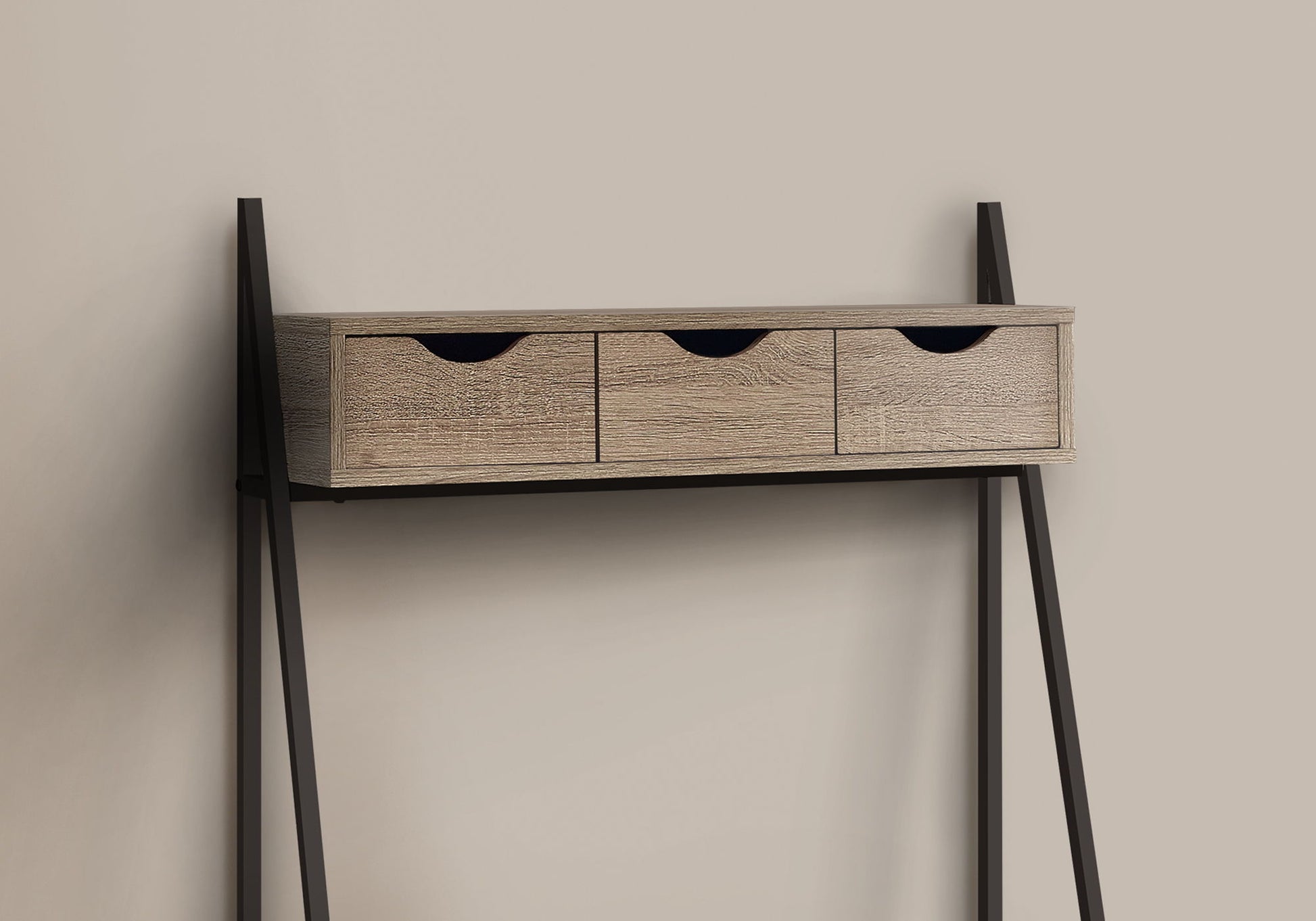 A contemporary, minimalist computer desk for home office use, featuring storage drawers and a leaning design with black metal legs, shown against a beige background.