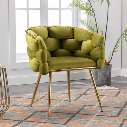 The Luxury Modern Simple Leisure Velvet Single Sofa Chair, featuring a tufted green design and gold metal legs, adds a stylish touch on a geometric rug by the window and potted plant in a bright room.