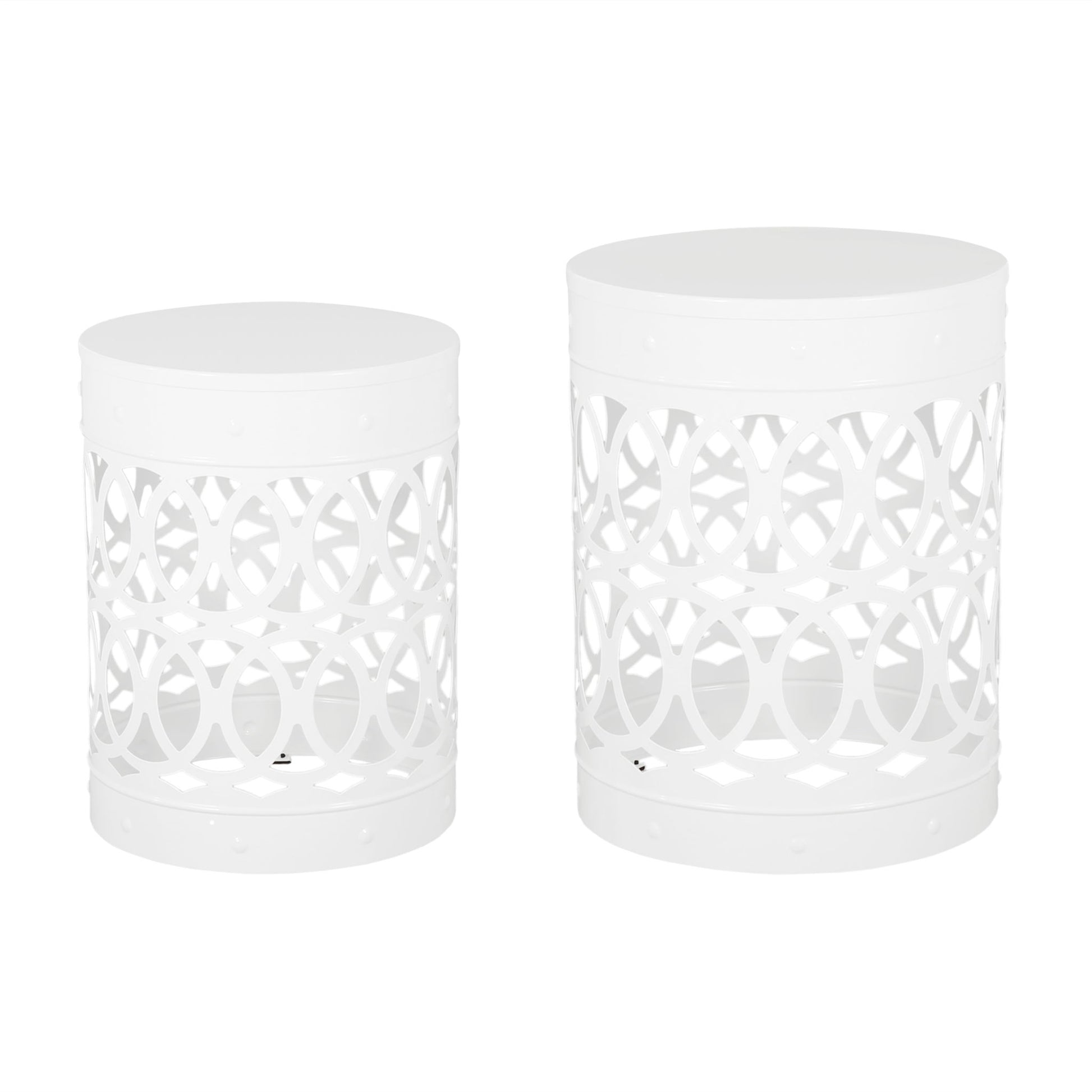 The Outdoor Metal S/2 End Table features two white, cylindrical tables with cut-out circular geometric patterns and solid tops, displayed side by side, with one table slightly taller and larger than the other.