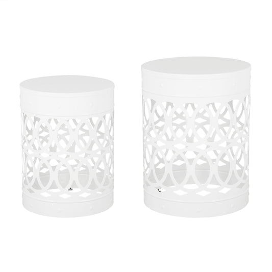 The Outdoor Metal S/2 End Table features two white, cylindrical tables with cut-out circular geometric patterns and solid tops, displayed side by side, with one table slightly taller and larger than the other.