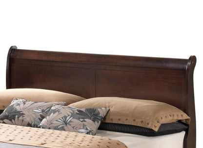 The Louis Phillipe - Storage Bed features a wooden sleigh-style headboard with a dark finish, showcased with tan bedding and decorative pillows in a black and gray leaf pattern.
