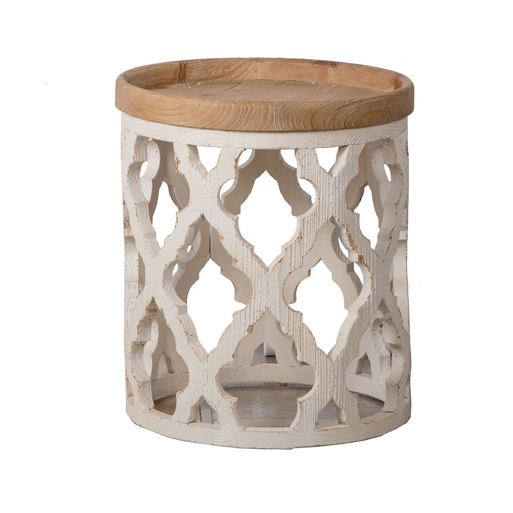 The Stylish Rustic Round Wooden Table features a light wooden top and a decorative white painted base with intricate cut-out patterns and a distressed rustic finish.