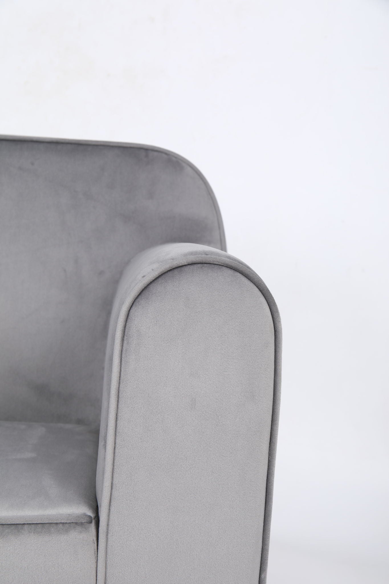 Close-up of the arm and backrest of the Durable Design Kids Club Sofa, featuring modern light gray upholstery, shown against a plain white background.