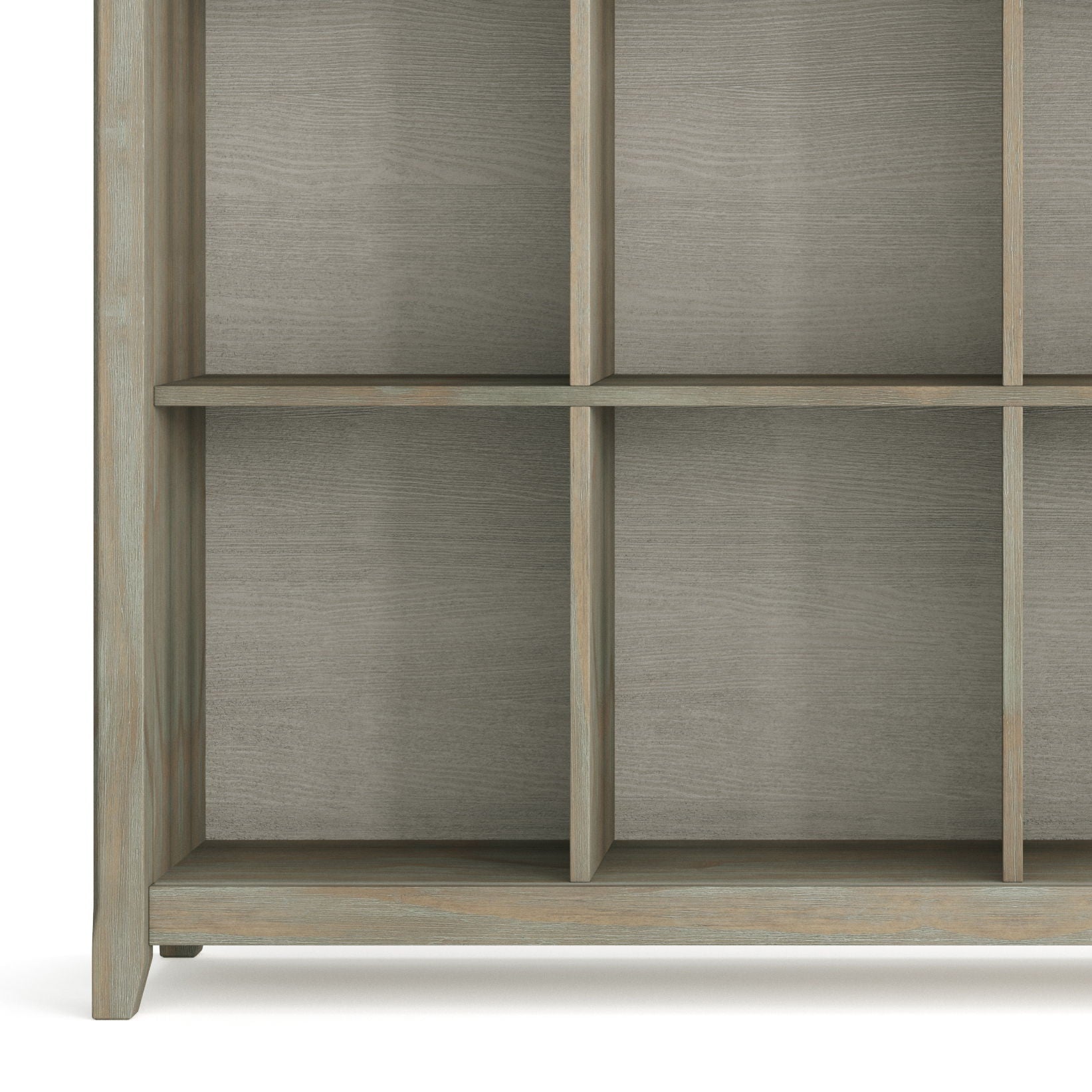 A close-up of the lower part of the Acadian - Handcrafted Cube Storage, showcasing its grid design with square compartments and a light grayish-brown finish. The shelves are empty.