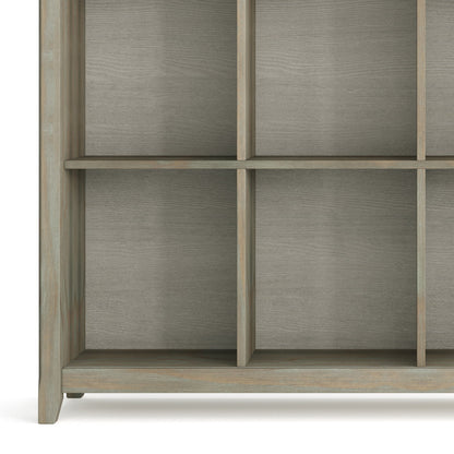 A close-up of the lower part of the Acadian - Handcrafted Cube Storage, showcasing its grid design with square compartments and a light grayish-brown finish. The shelves are empty.