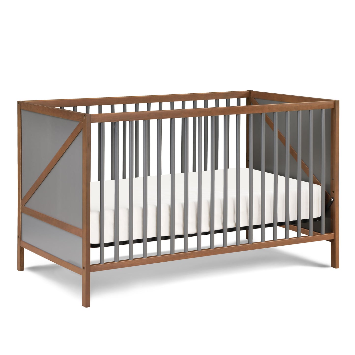 The Pixie Zen 3-in-1 Crib in Walnut features a modern wooden frame, gray slats, and angled side design. It includes a white mattress with no bedding or decorations.