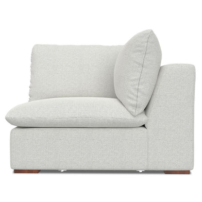 The Jasmine - Handcrafted Sofa and Ottoman features a light gray upholstered corner chair with thick, plush cushions and a low backrest, shown from the side against a white background.