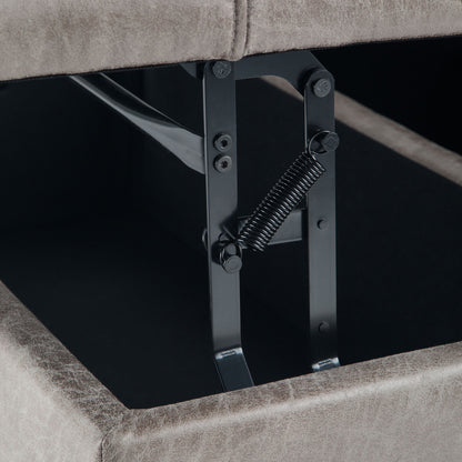 Close-up of the metal hinge and spring mechanism inside the Harrison - Upholstered Coffee Table Storage Ottoman, highlighting the opening hardware beneath its lifted cushioned lid.