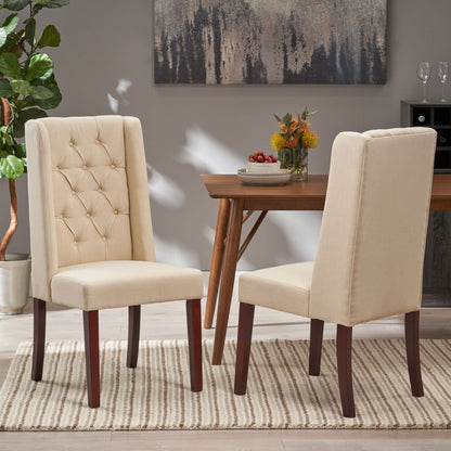 Two Sophisticated Tufted Dining Chairs With High Back Design in beige sit on a striped rug in a modern dining room, paired with a wooden table, decorative plant, and wall art in the background.